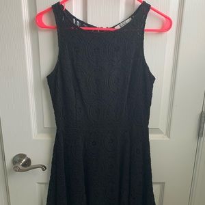 Black, mid thigh length dress.